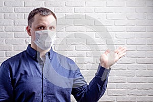 Medical mask, protection against coronavirus and other viruses on the white brick wall background