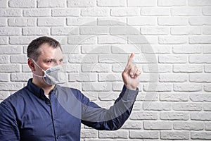 Medical mask, protection against coronavirus and other viruses on the white brick wall background