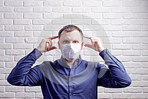 Medical mask, protection against coronavirus and other viruses on the white brick wall background