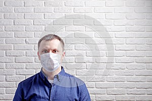 Medical mask, protection against coronavirus and other viruses on the white brick wall background