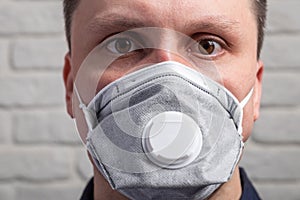 Medical mask, protection against coronavirus and other viruses on the white brick wall background