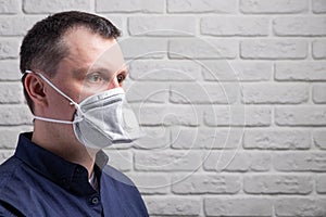 Medical mask, protection against coronavirus and other viruses on the white brick wall background