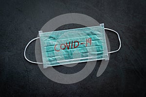 Medical mask, protective mask with COVID-19 text. Chinese coronavirus outbreak situation. Novel coronavirus COVID-19, WUHAN virus