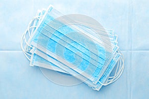 Medical mask, surgical protective masks on blue background. Disposable face mask cover the mouth and nose. Healthcare and medical photo