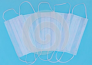 Medical masks on a blue background to prevent the spread of the virus, coronavirus, flu, colds, top view. The concept of