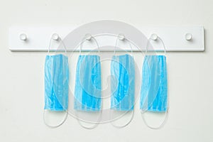 Medical masks hanging on a white hanger