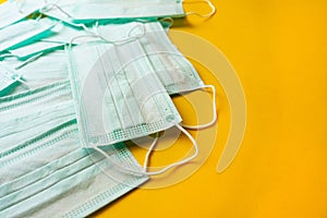 Medical masks are laid out on a yellow background