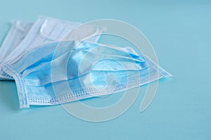 Medical masks lie on a blue background. Soft focus, horizontal image