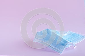 Medical masks on a pink background. Soft focus, horizontal image