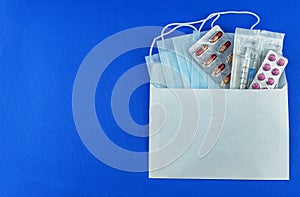 Medical masks and tablets on a blue background,