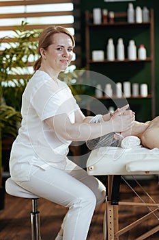 medical massage therapist massaging clients face