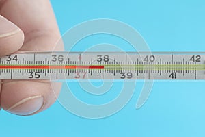 Medical mercury thermometer showing the temperature of 38 Â°C