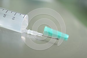 Medical needle on plastic syringe.