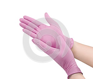 Medical nitrile gloves.Two pink surgical gloves isolated on white background with hands. Rubber glove manufacturing, human hand