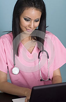 Medical nurse assistant using laptop