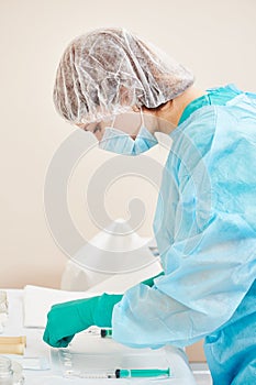 Medical nurse assists at surgeon operation