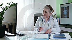 Medical officer works online communicates using web camera on computer using modern technologies as patient advised