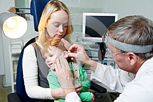 Medical otitus examination of child doctor photo