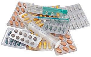 Medical pack of pills and syringe on white