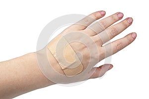 Medical patch plaster on woman hand isolated on the white background