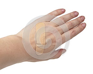 Medical patch plaster on woman hand isolated on the white background