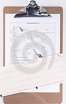 Medical patient form with pen and cardiogram