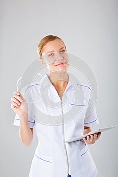 Medical person: Nurse / young doctor portrait. Confident young woman medical professional on white background.