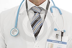 Midsection of doctor in labcoat with stethoscope at clinic photo