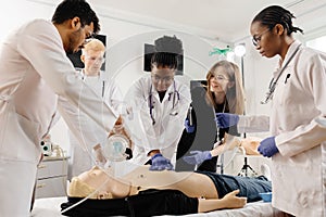 Medical personnel demonstrating cpr on dummy