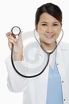 Medical personnel holding up a stethoscope