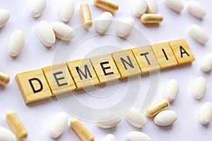 The medical phrase dementia on different pills and capsules background. Pharmacy theme, health care photo