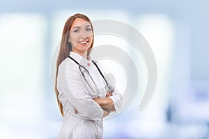 Medical physician doctor woman over blue clinic background.