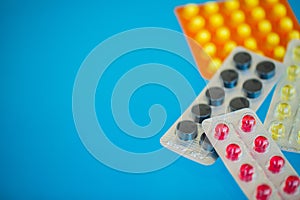 Medical Pills. Colored Pills And Capsule On Blue Background. Pharmacy Theme, Capsule Pills With Medicine Antibiotic in Packages