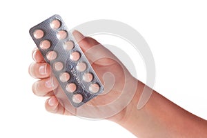 Medical pills container on a female hand, isolated