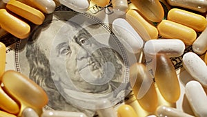 Medical pills lying on US Dollar Bill move over. Big pharma conspiracy theory