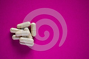 Medical pills on pink background