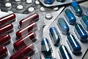 Medical pills. Red, blue and white tablet in transparet blister park