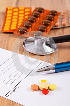 Medical pills, tablets or supplements with prescription and stethoscope, health care concept