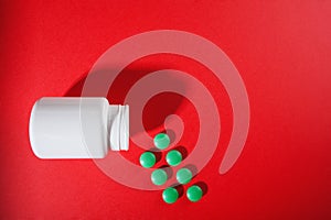 Medical pills vitamins on a colored background with a vial