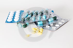 Medical pills in white, blue and other colors. Pills in plastic package. Concept of healthcare and medicine