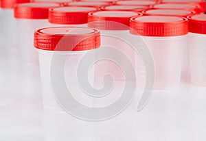 Medical plastic container for collecting tests on the background of other containers. Concept: passing medical tests