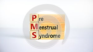 Medical and PMS, premenstrual syndrome symbol. Wooden cubes and blocks with words `PMS, premenstrual syndrome`. Beautiful white