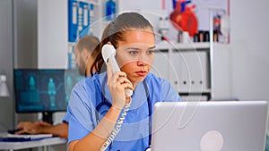 Medical practitioner answering phone calls