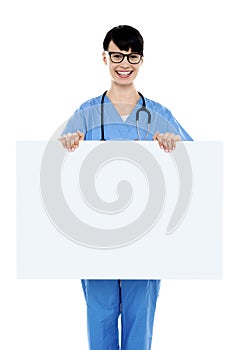 Medical practitioner holding blank ad board