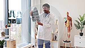 Medical practitioner studying CT scans in doctor's office