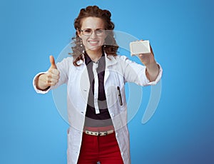 Medical practitioner woman with soap bar showing thumbs up