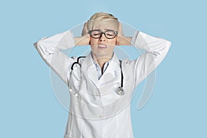 Medical problems, overwork or coronacrisis. Sad woman doctor in white coat with stethoscope