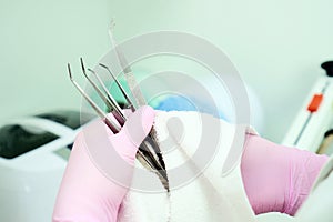 A medical professional cleans and disinfects a medical instrument from germs. Stylishness and cleanliness in dentistry and medical photo