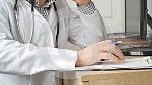 Medical professional doctor writing RX prescription on clipboard