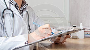 Medical professional doctor writing RX prescription on clipboard